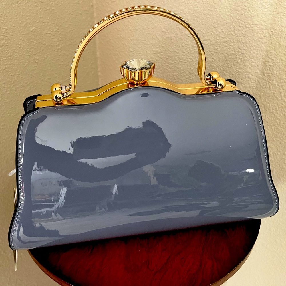 Gray blue hand bag with strap and gold frame